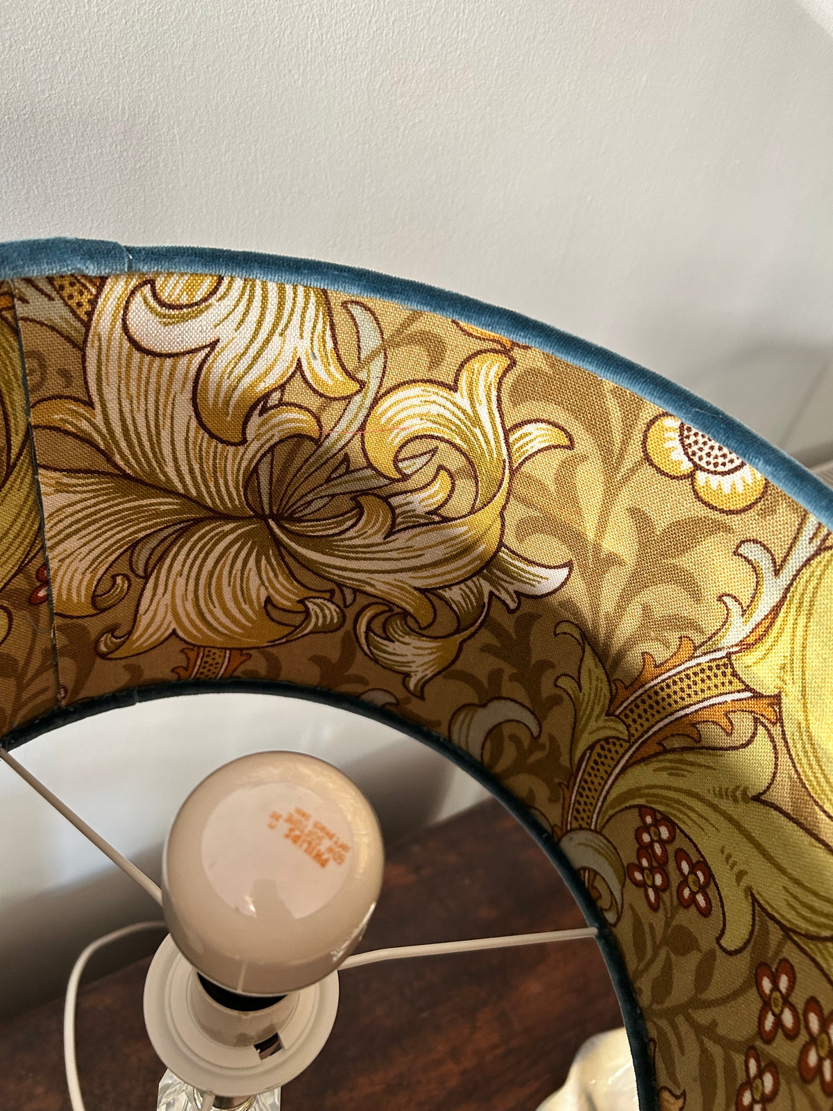 Close-up of the Golden Lily fabric lining, blue velvet rim and internal lampshade supports.