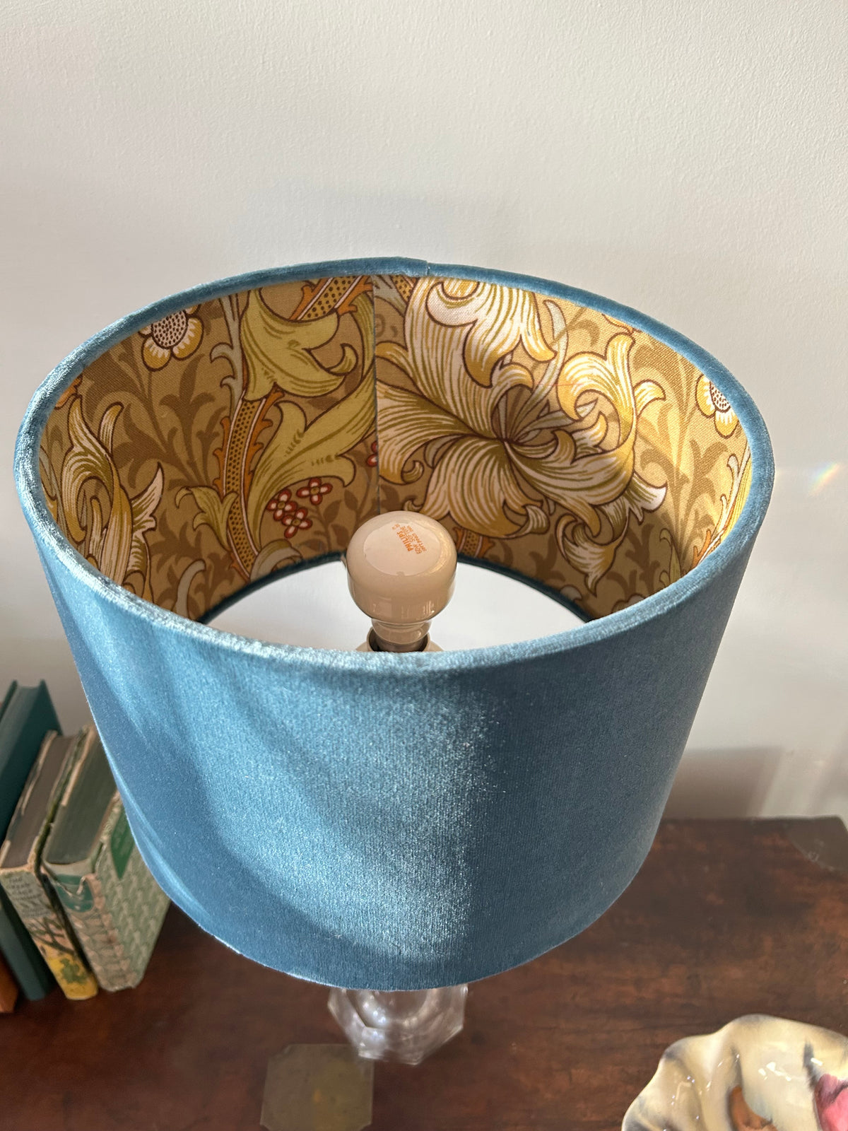 View into the blue velvet lampshade showing its William Morris Golden Lily botanical lining.