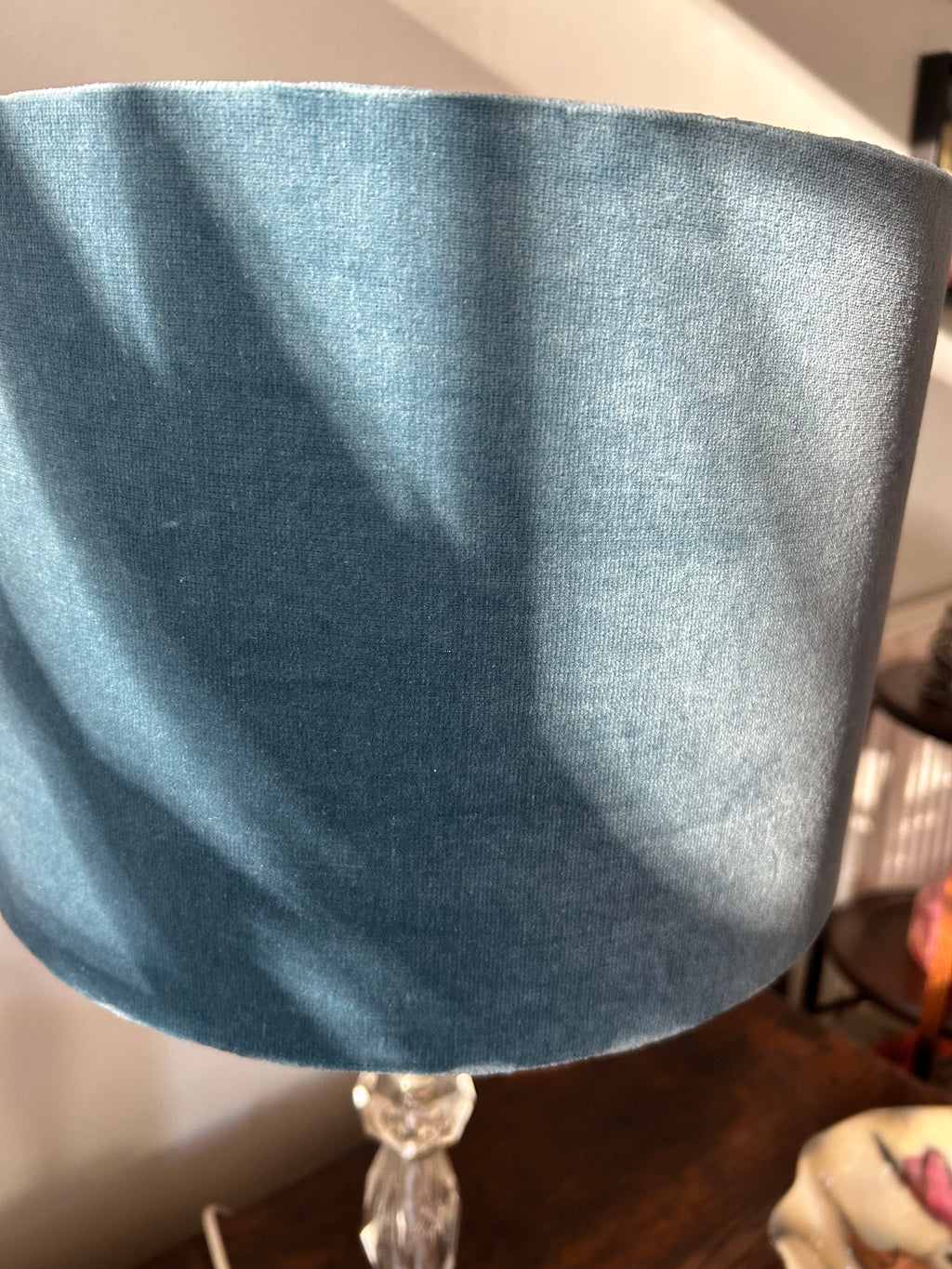 Close-up of the blue velvet lampshade exterior showing its soft pile and sheen.